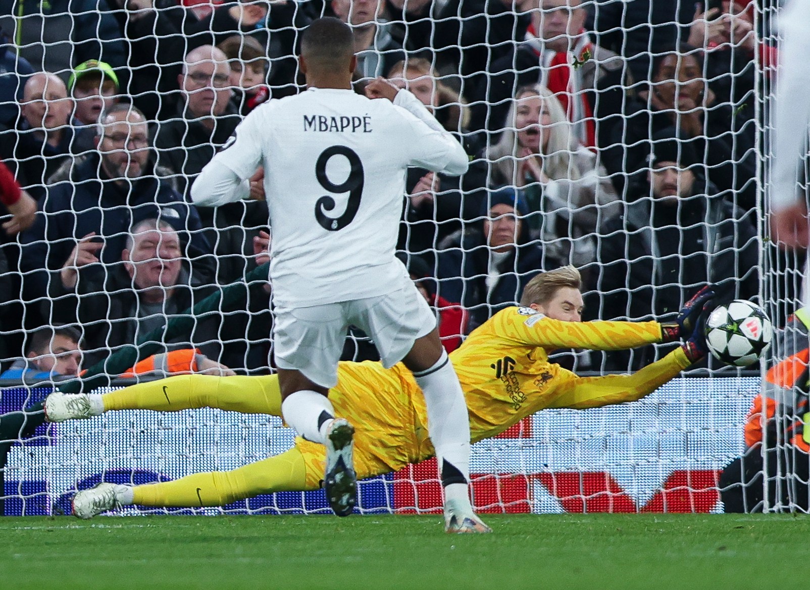 Caoimhin Kelleher of Liverpool making a penalty save against Kylian Mbappé.