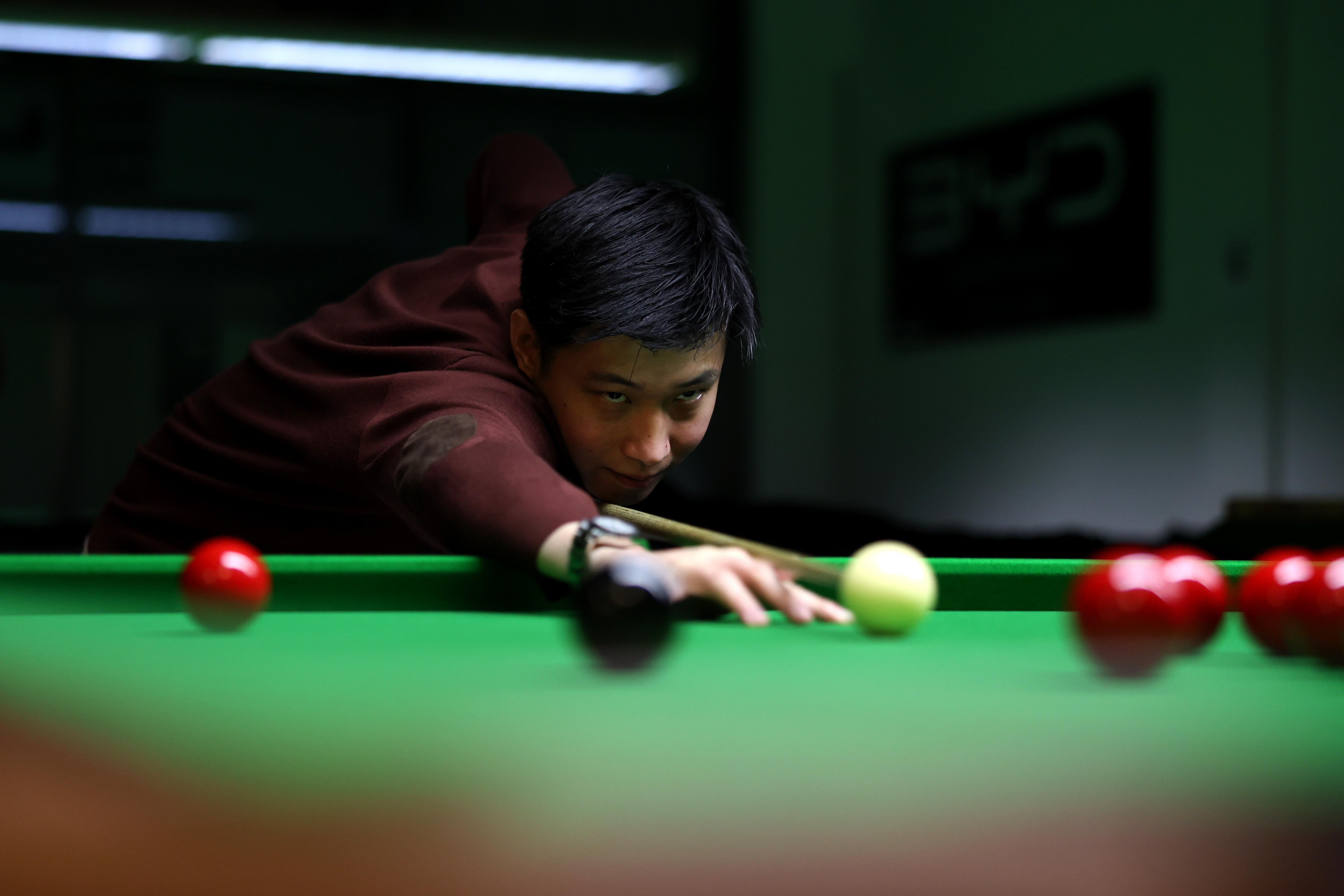 Zhao Xintong competing in a snooker match.